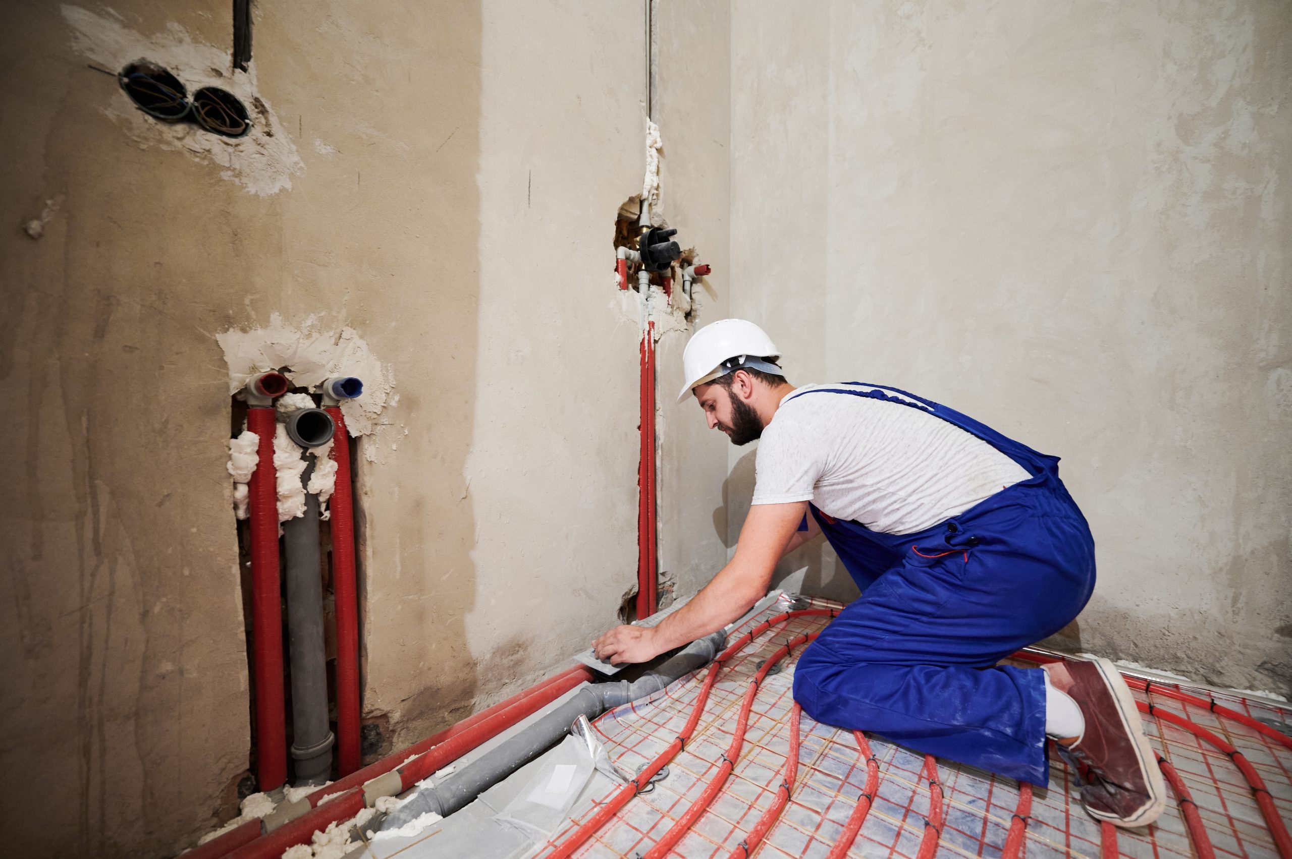 bearded-plumber-installing-underfloor-heating-syst-2025-01-16-22-52-20-utc.jpg